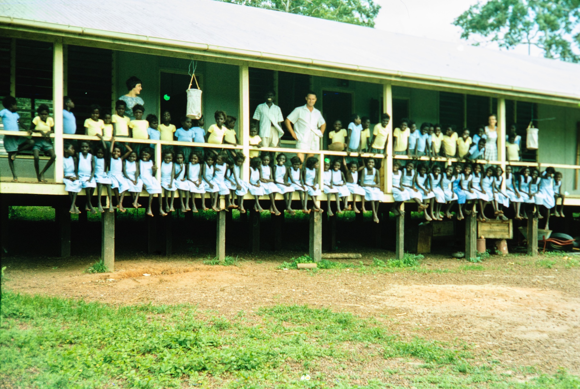 Students lined up on verandah with teachers 