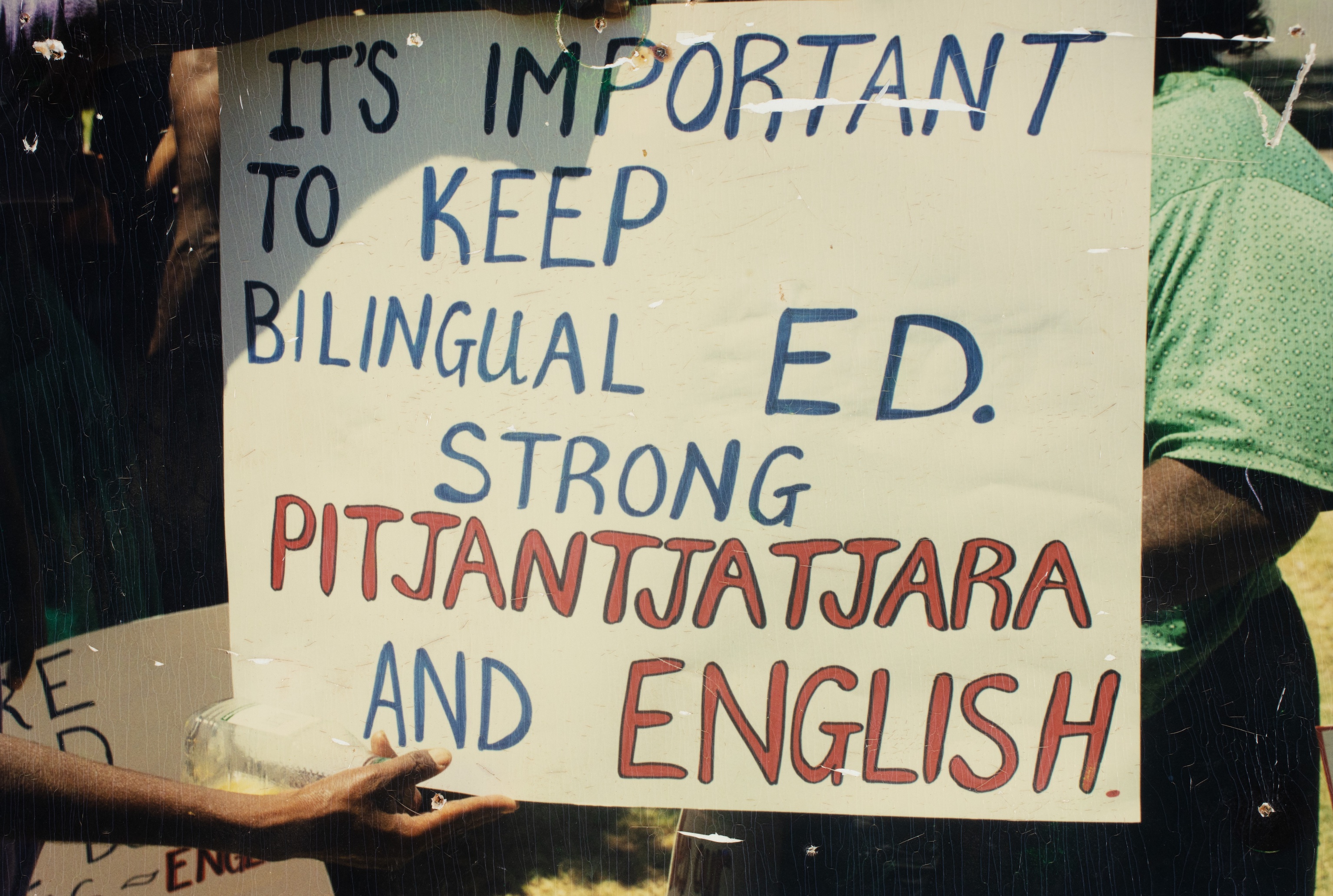 Sign reading: It's important to keep bilingual ed. strong. Pitjantjatjara and English